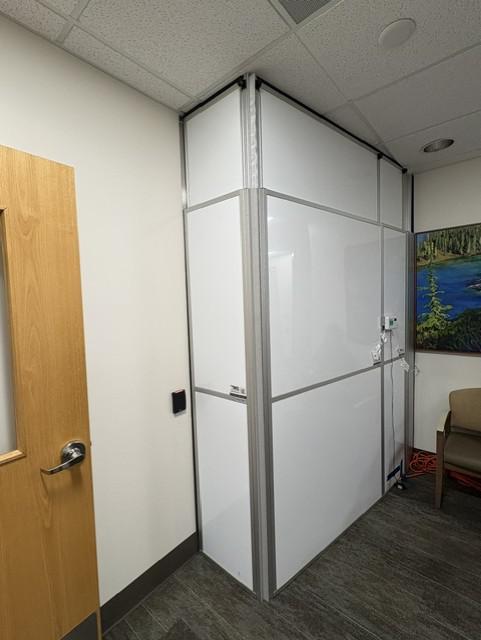 Sealed containment wall with a room pressure monitor used to track negative pressure during renovation.