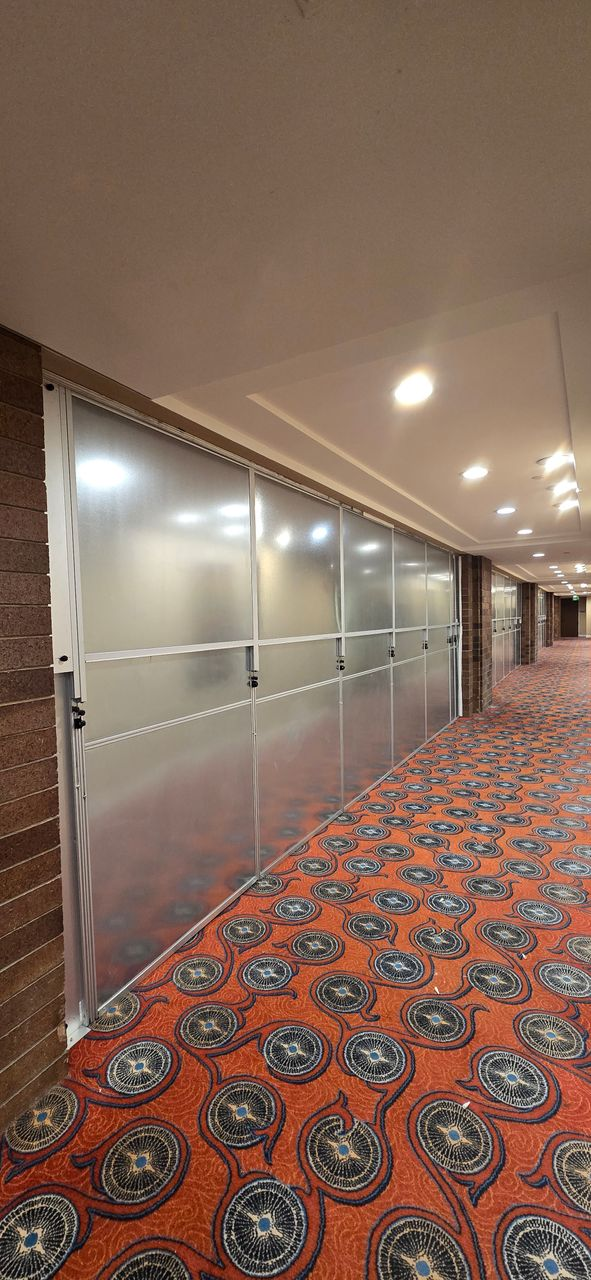 Modular hard wall containment installed along a Hilton Anatole hotel corridor, creating a secure dust-controlled construction barrier during an occupied hotel renovation.