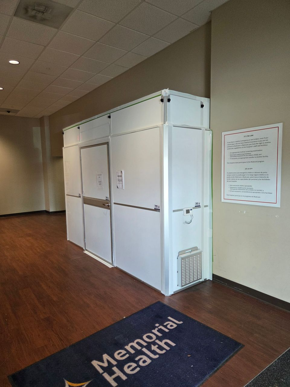 Healthcare containment enclosure with modular hard wall panels and negative air monitoring installed by Temporary Wall Systems to isolate the Day Surgery renovation at Memorial Health University Medical Center.