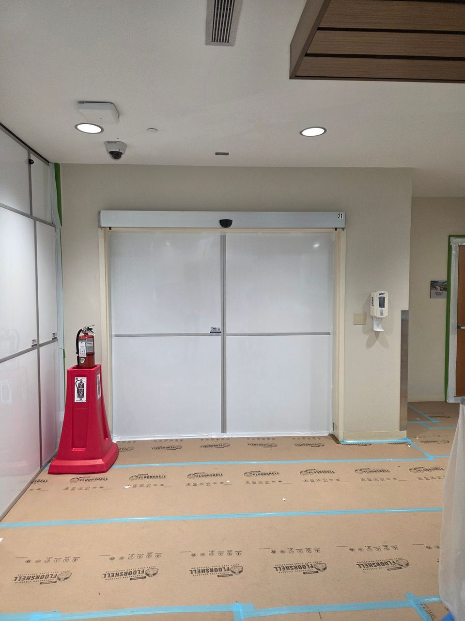 Temporary Wall Systems modular hard wall containment with sliding access door and negative air containment protecting the Day Surgery renovation entrance at Memorial Health University Medical Center.