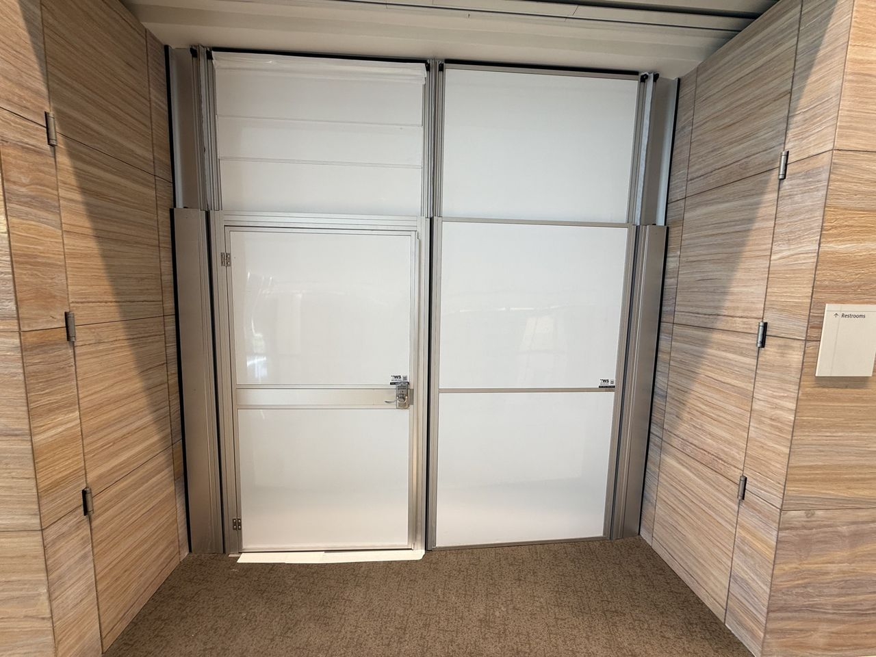 Freestanding hard wall containment system installed by Temporary Wall Systems to isolate a second-floor healthcare construction area while maintaining safe access in an occupied office environment.