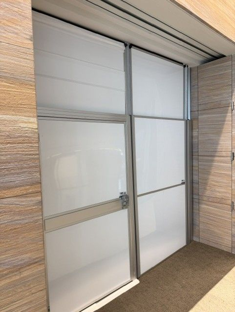 Modular temporary construction walls with an integrated access door providing secure construction containment inside an occupied office building during a healthcare renovation.