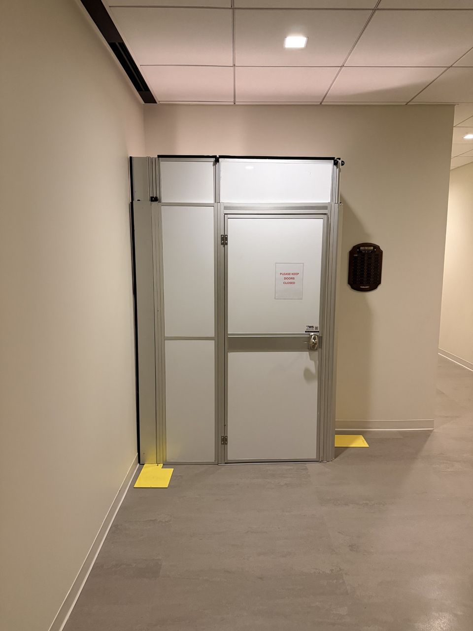 Temporary construction wall system installed by Temporary Wall Systems to secure a stairwell renovation area while maintaining safety and controlled access in an occupied commercial building.