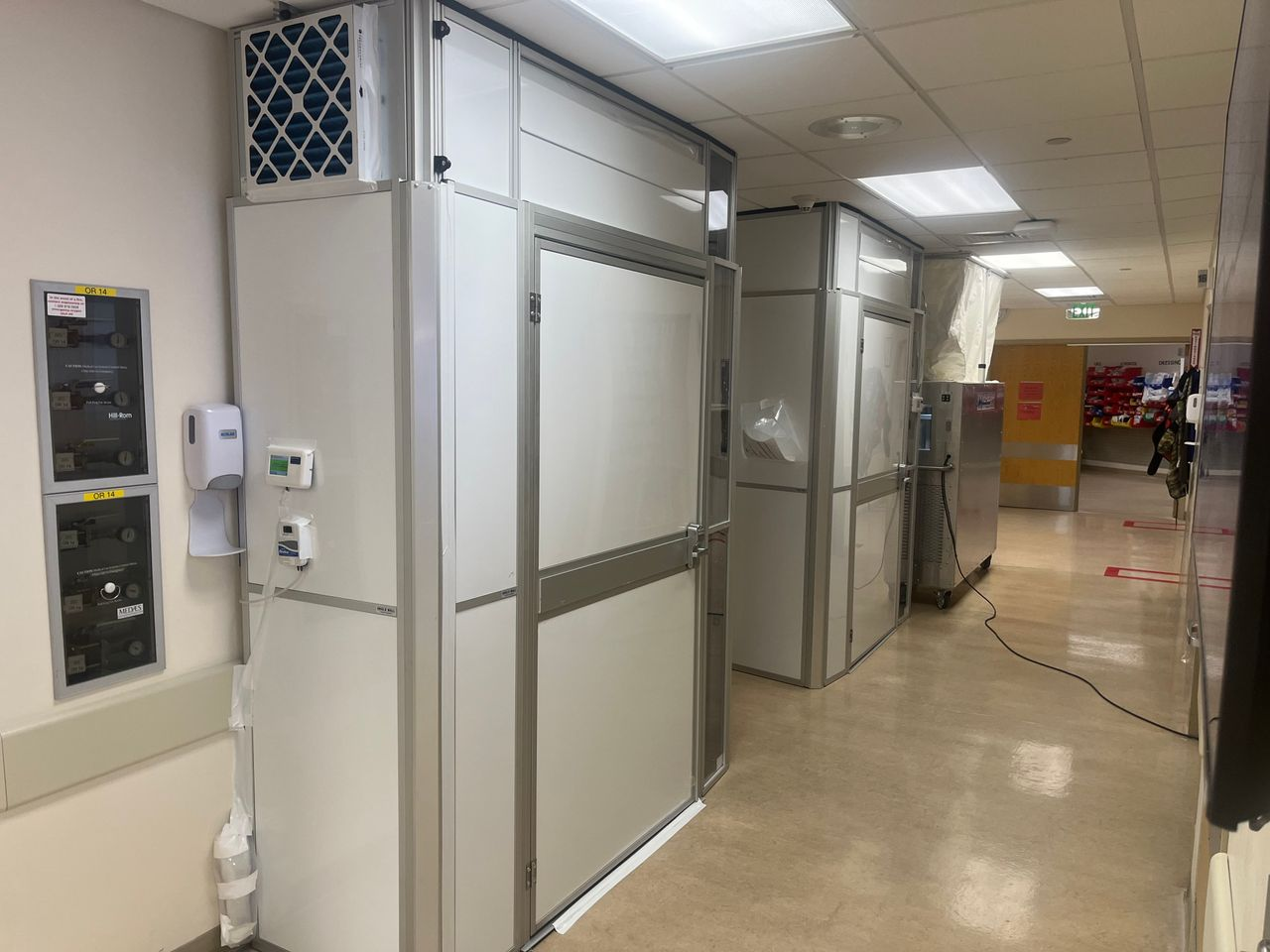 Temporary Wall Systems healthcare construction containment with integrated anterooms and negative air management supporting phased operating room upgrades in an occupied surgical suite.