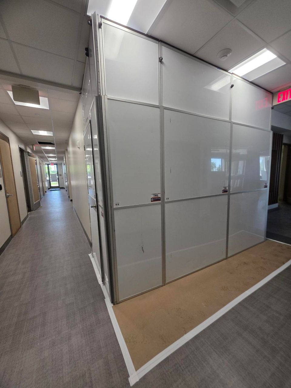 Temporary Wall Systems modular hard wall containment surrounding an elevator replacement project in a healthcare facility, helping separate construction from occupied spaces while maintaining clear corridor access.