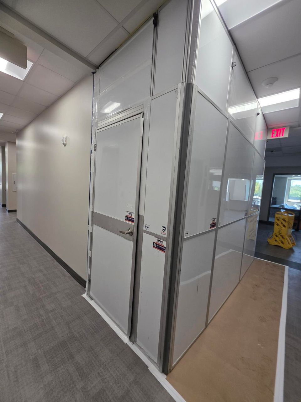Full-height modular hard wall containment enclosure installed around an elevator renovation area, providing clean healthcare construction containment with secure access doors.