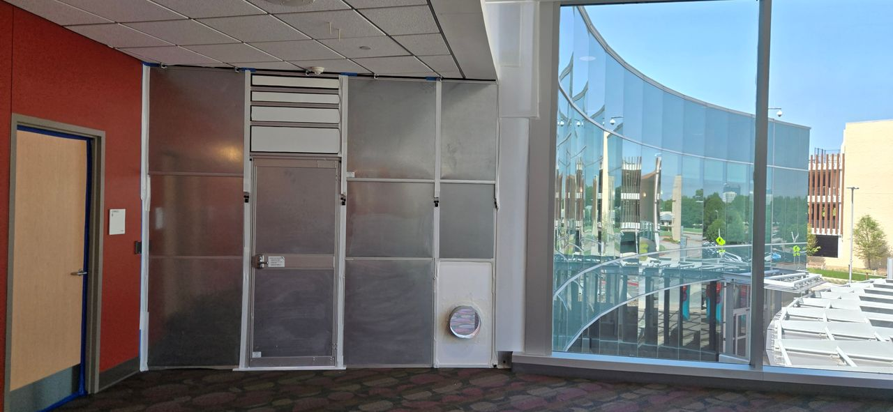 Custom-fit modular hard wall containment following curved architecture with an integrated door and duct connection at Children’s Health Plano.