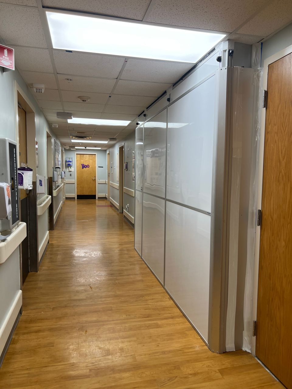 Temporary Wall Systems modular hard wall containment installed along an active hospital corridor during emergency department expansion construction at Ochsner Baptist in New Orleans.