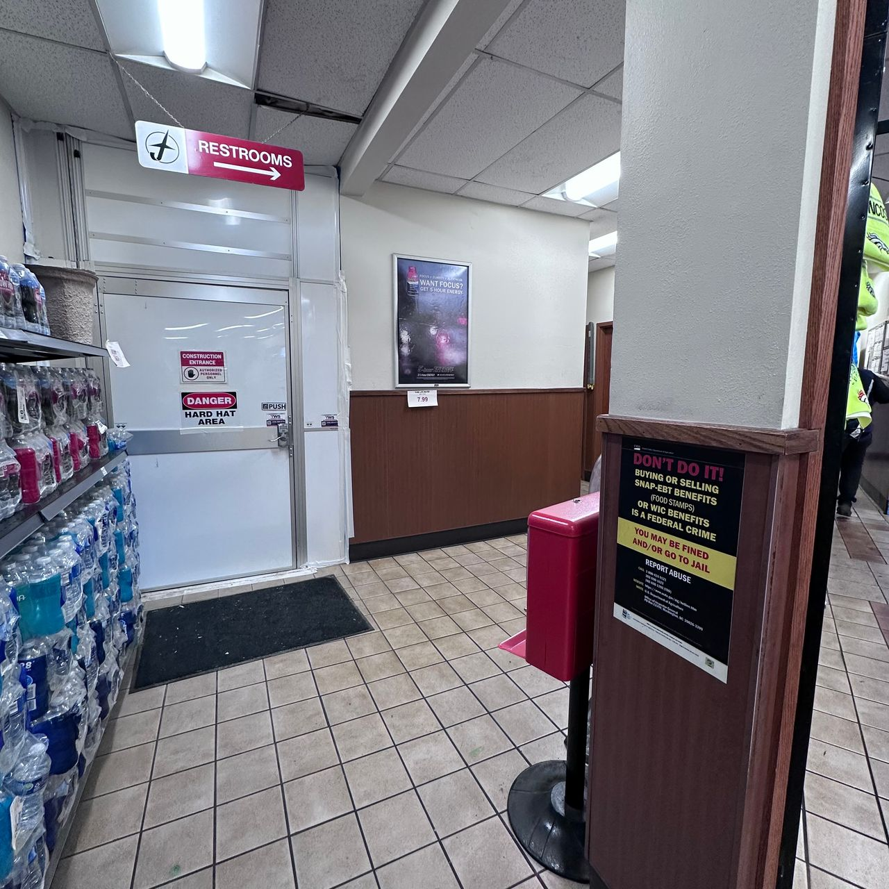 Temporary walls creating a protected construction entrance and maintaining customer access routes during a multi-phase travel center remodeling project.