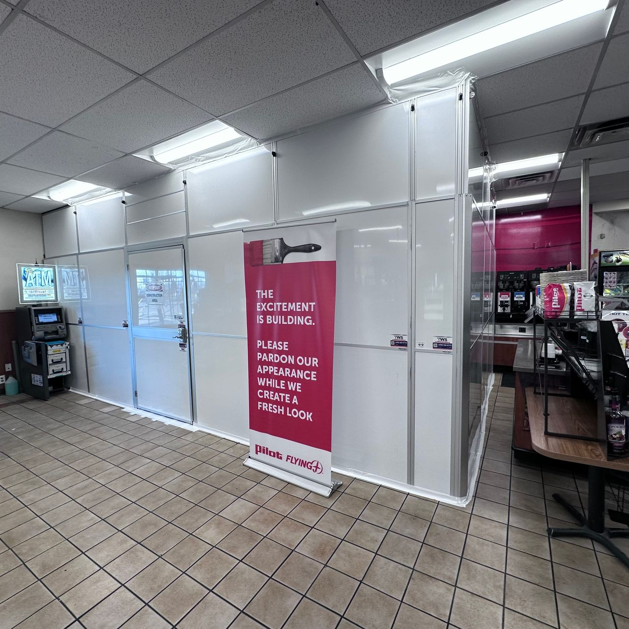 Temporary Wall Systems construction containment wall with secure access door supporting a phased Pilot Travel Center renovation in an occupied retail environment.