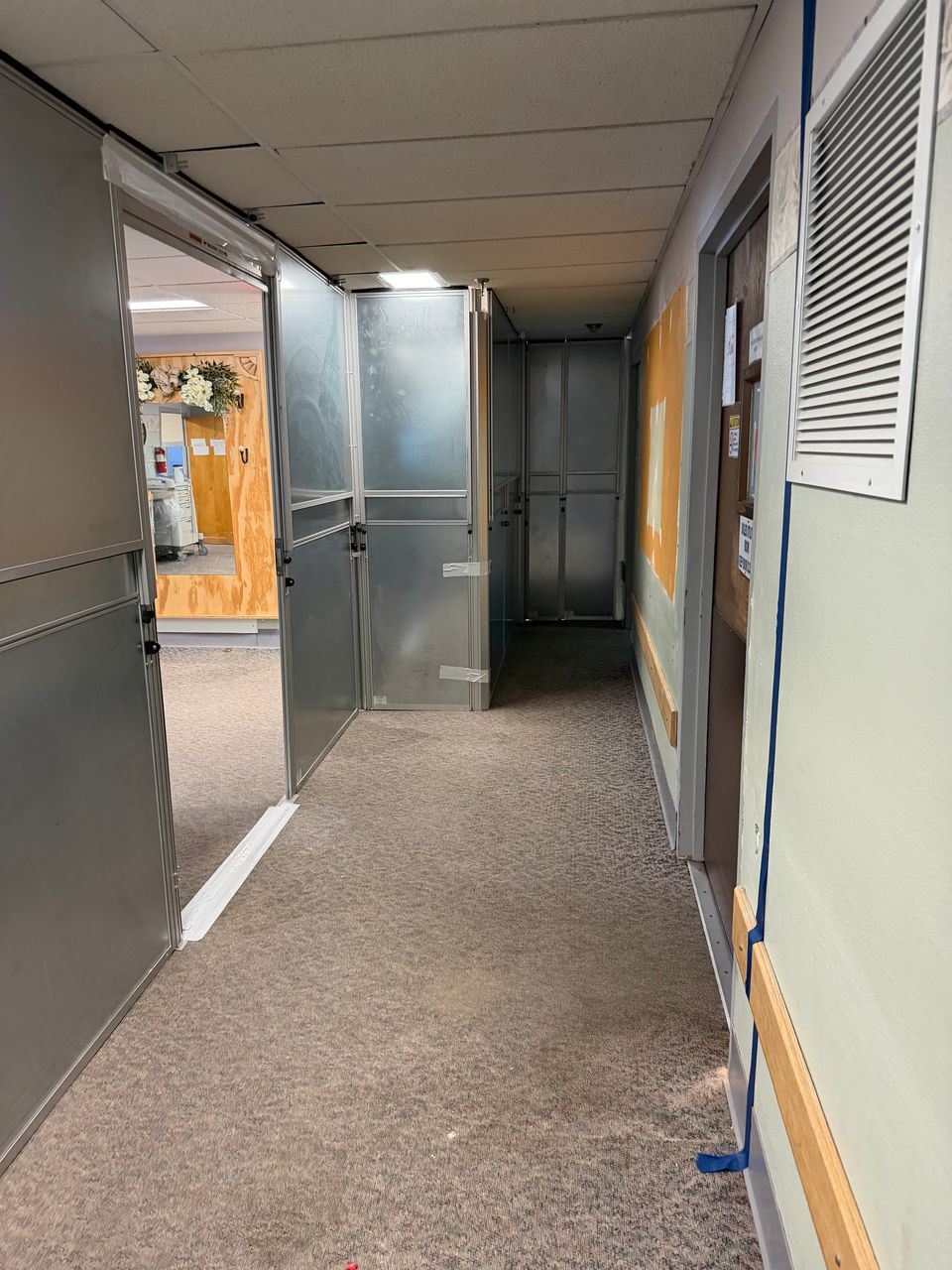 Temporary Wall Systems modular hard wall containment corridor installed inside an active healthcare facility to separate renovation work from occupied resident areas.