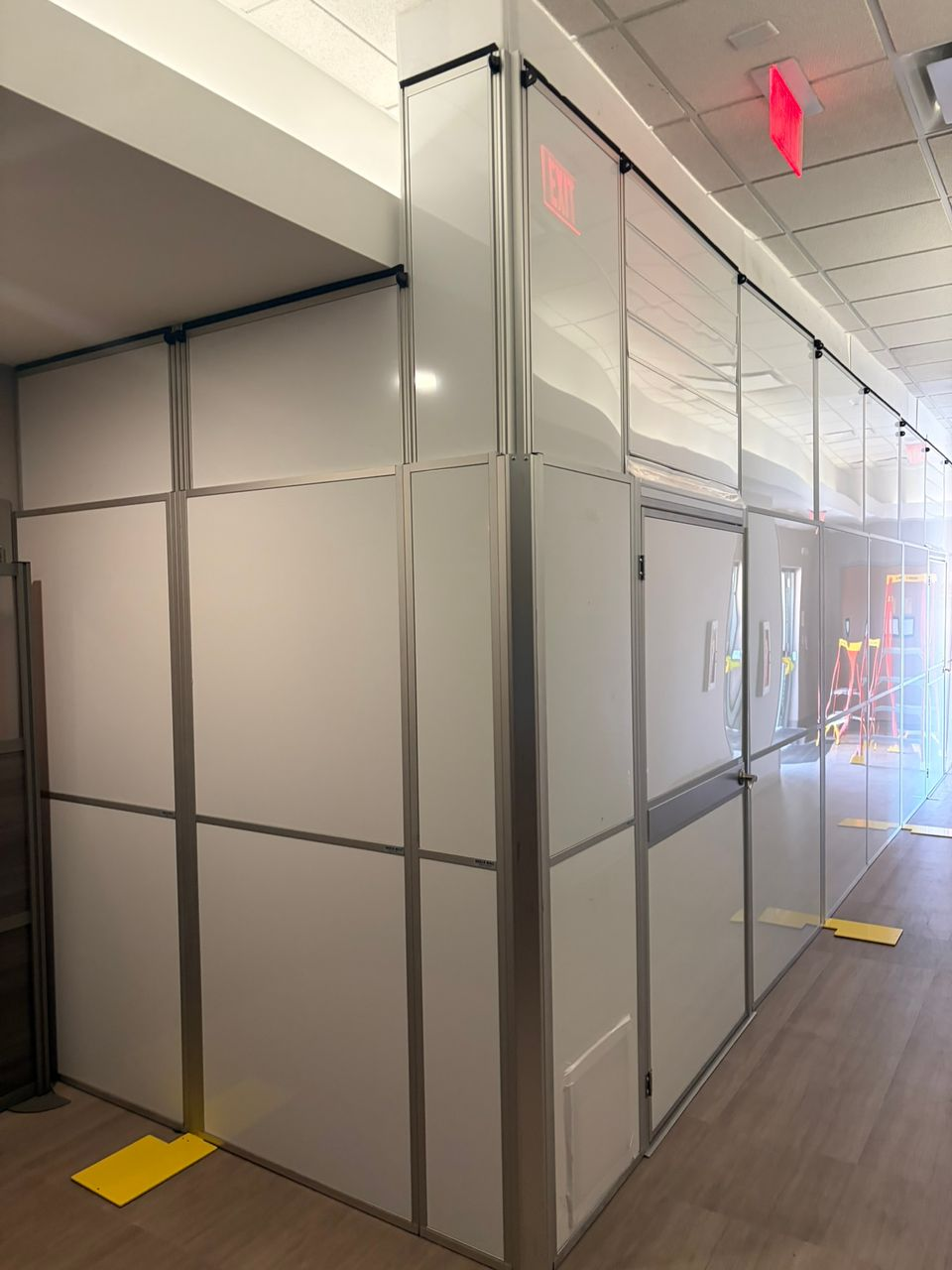 Healthcare construction containment featuring full-height temporary walls and integrated access doors supporting safe renovations within an active oncology facility.