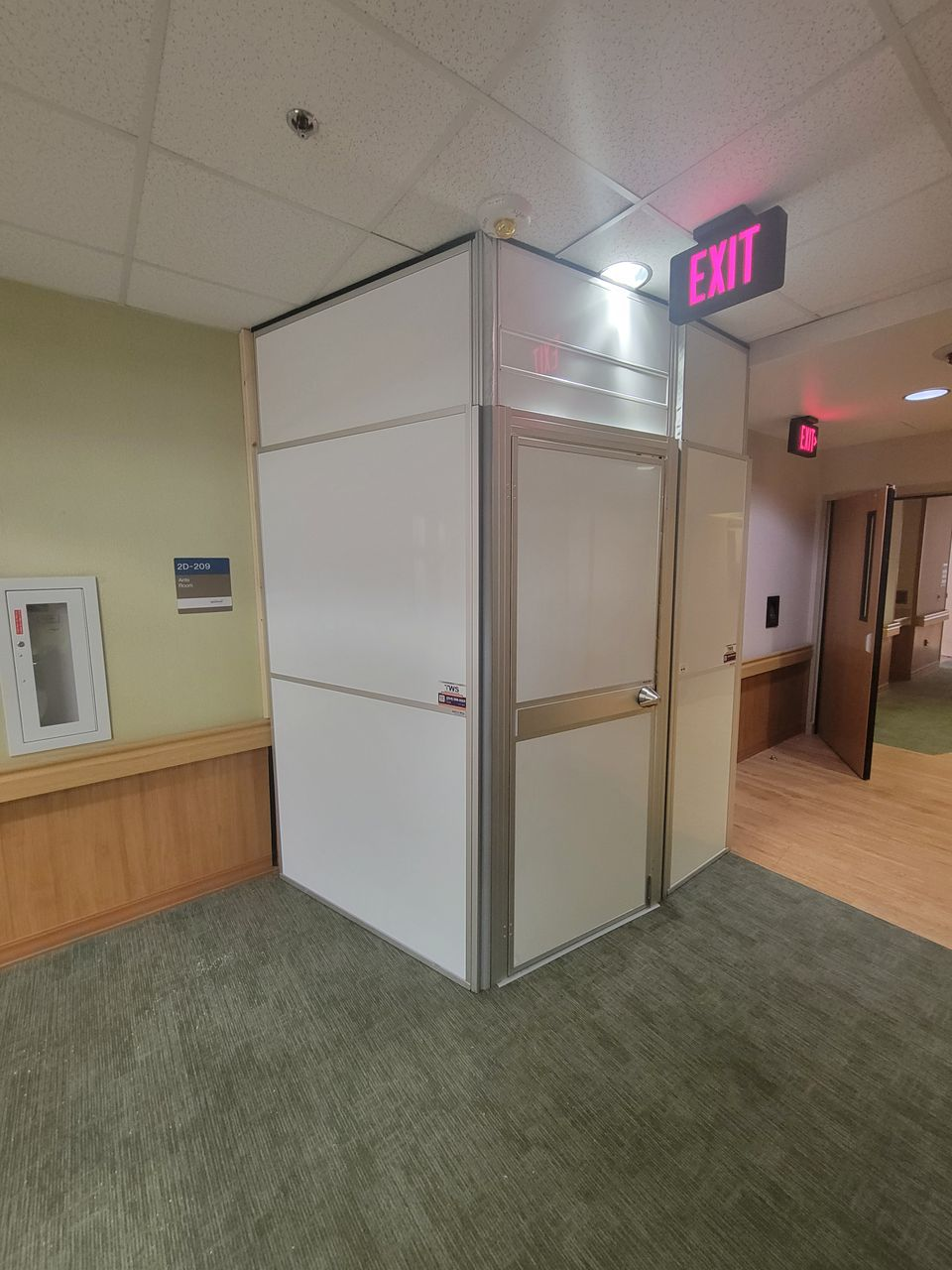 Healthcare construction containment enclosure with anti-ligature design features installed in a VA Hospital inpatient ward using modular temporary wall systems.