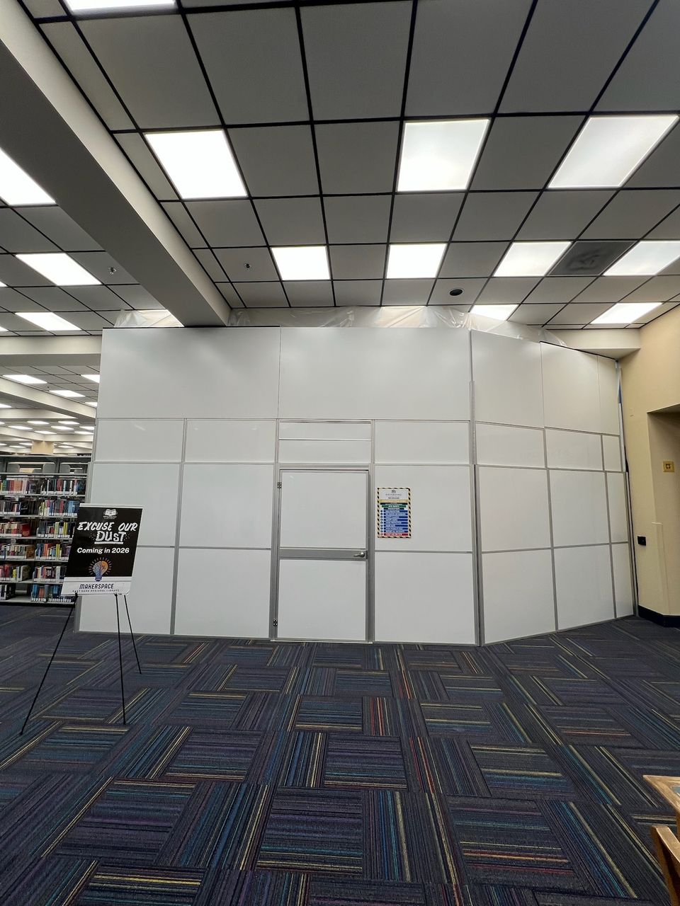 Temporary Wall Systems modular hard wall containment installed inside an occupied library during a Makerspace renovation project in New Orleans