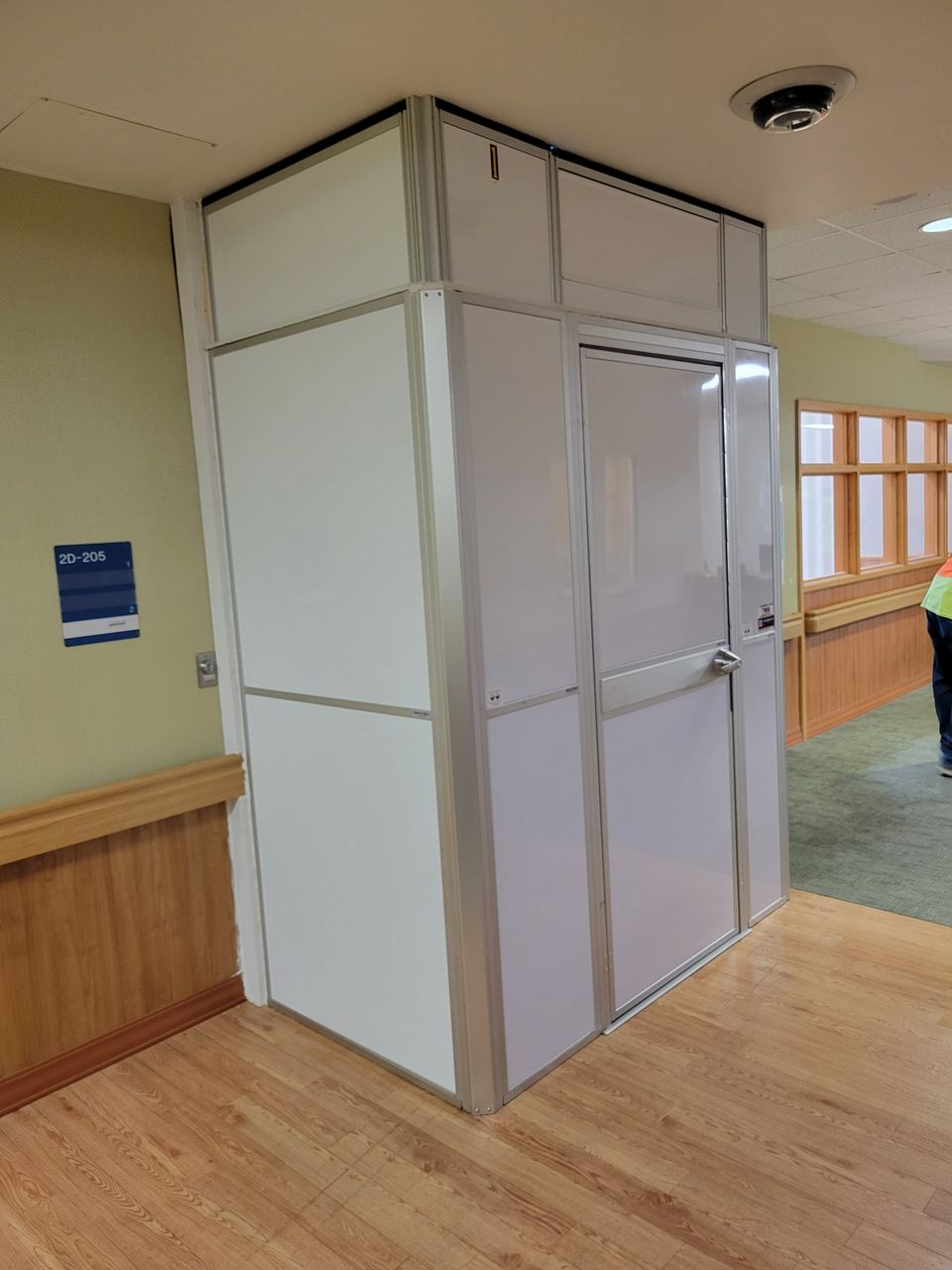 Anti-ligature modular hard wall containment room installed in a VA Hospital mental health unit corridor during healthcare renovation by Temporary Wall Systems.