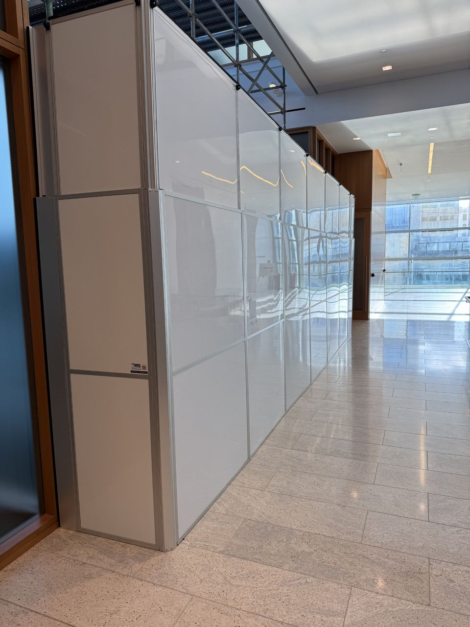 Modular hard wall containment installed in an occupied Oklahoma City office tower to separate executive office renovation work from active business operations.