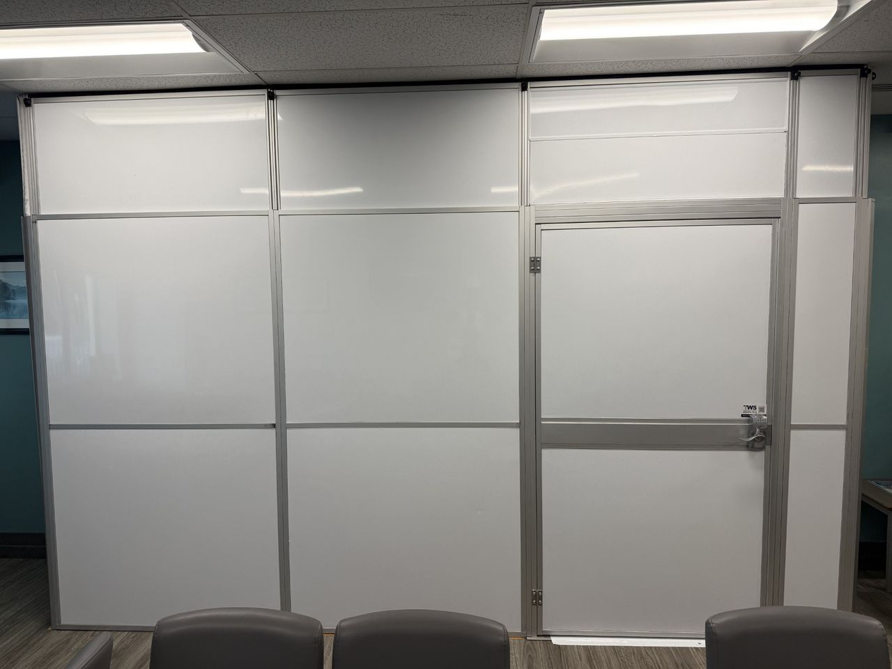 Modular hard wall healthcare containment system featuring secure keypad access to maintain infection control during hospital renovation work.