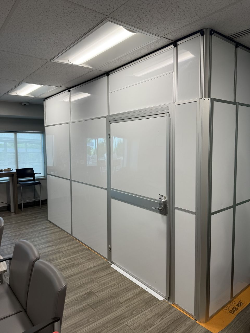 ICRA healthcare construction containment wall with controlled access door installed adjacent to an occupied waiting room at a VA medical center renovation.