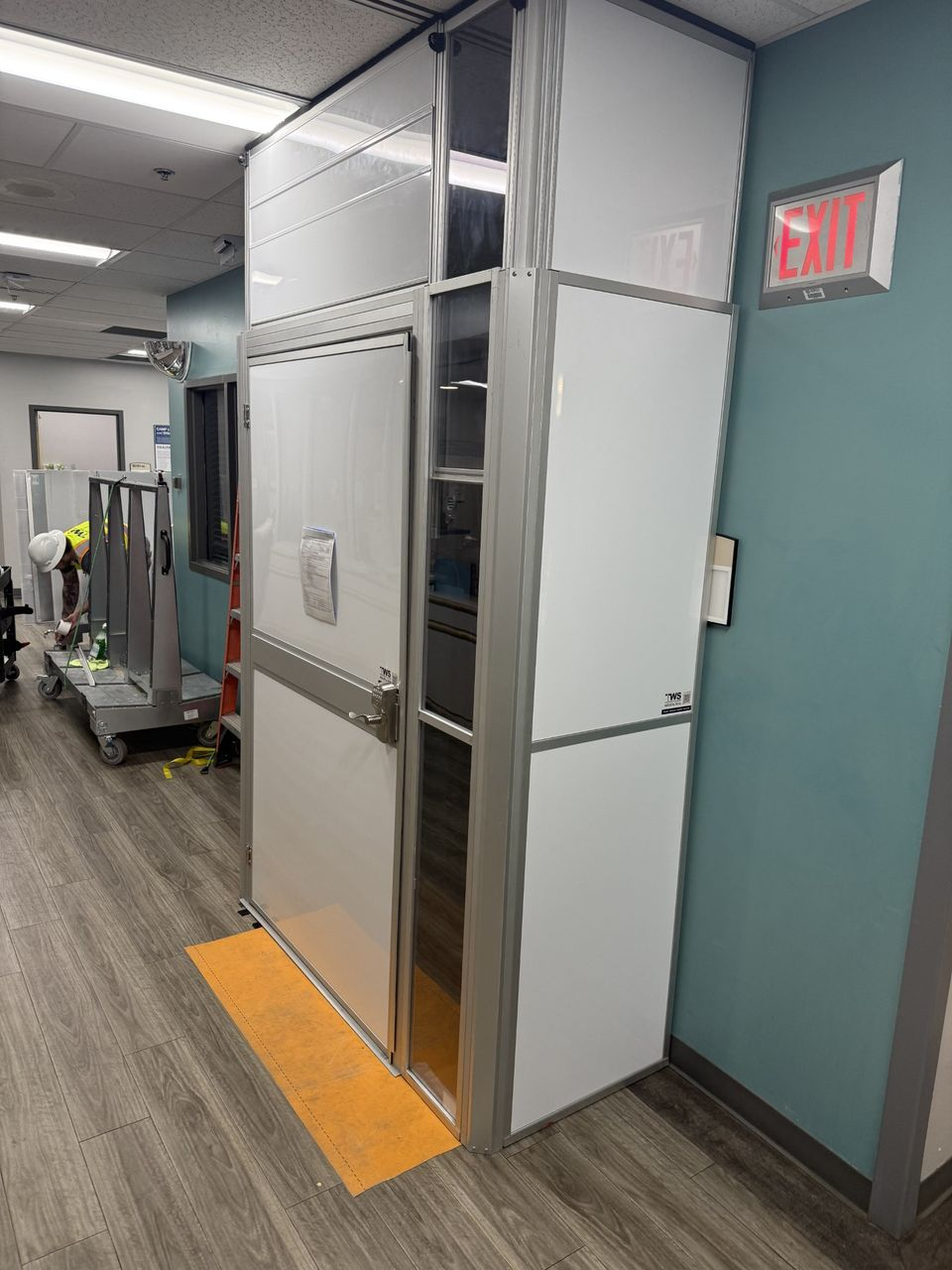 Modular hard wall healthcare anteroom creating a controlled transition point between occupied hospital areas and a construction zone.