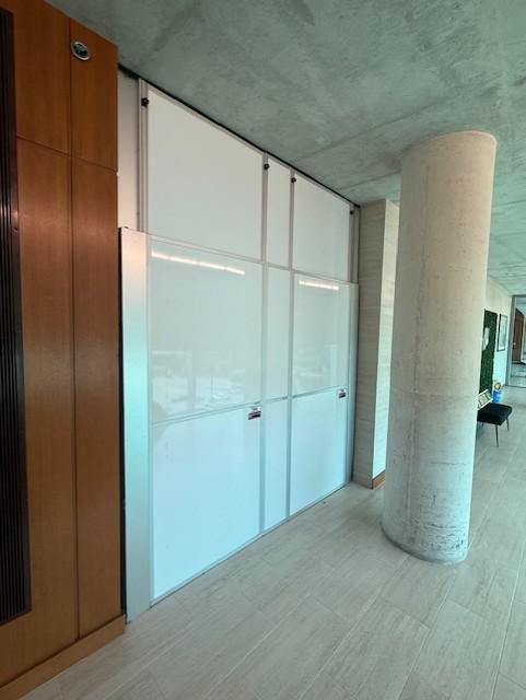 Hard wall containment separating construction areas at a university event venue in Waco, TX