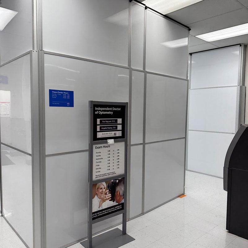 grey temporary wall in front of a sign