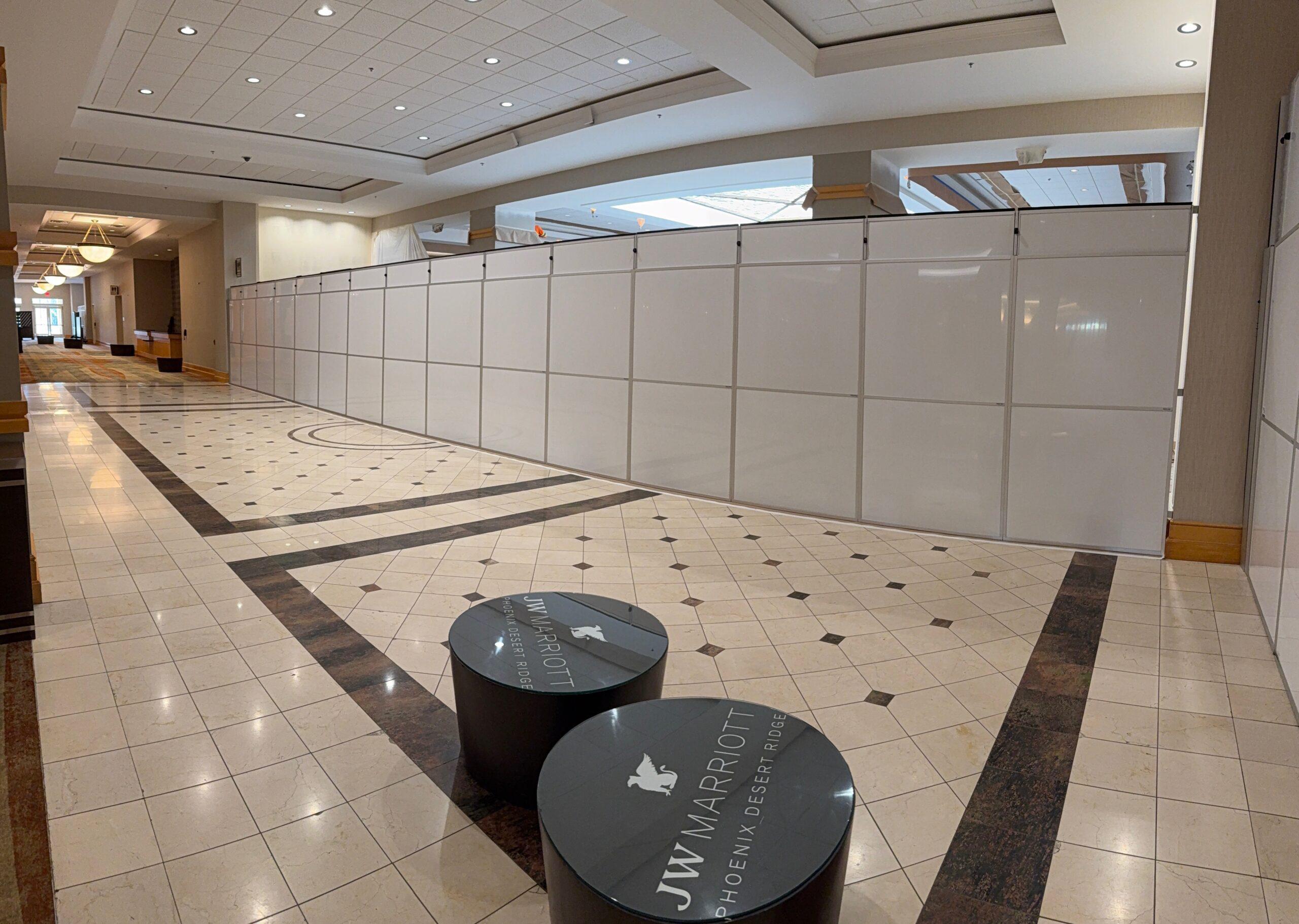 ballroom floor with tables and white partition wall