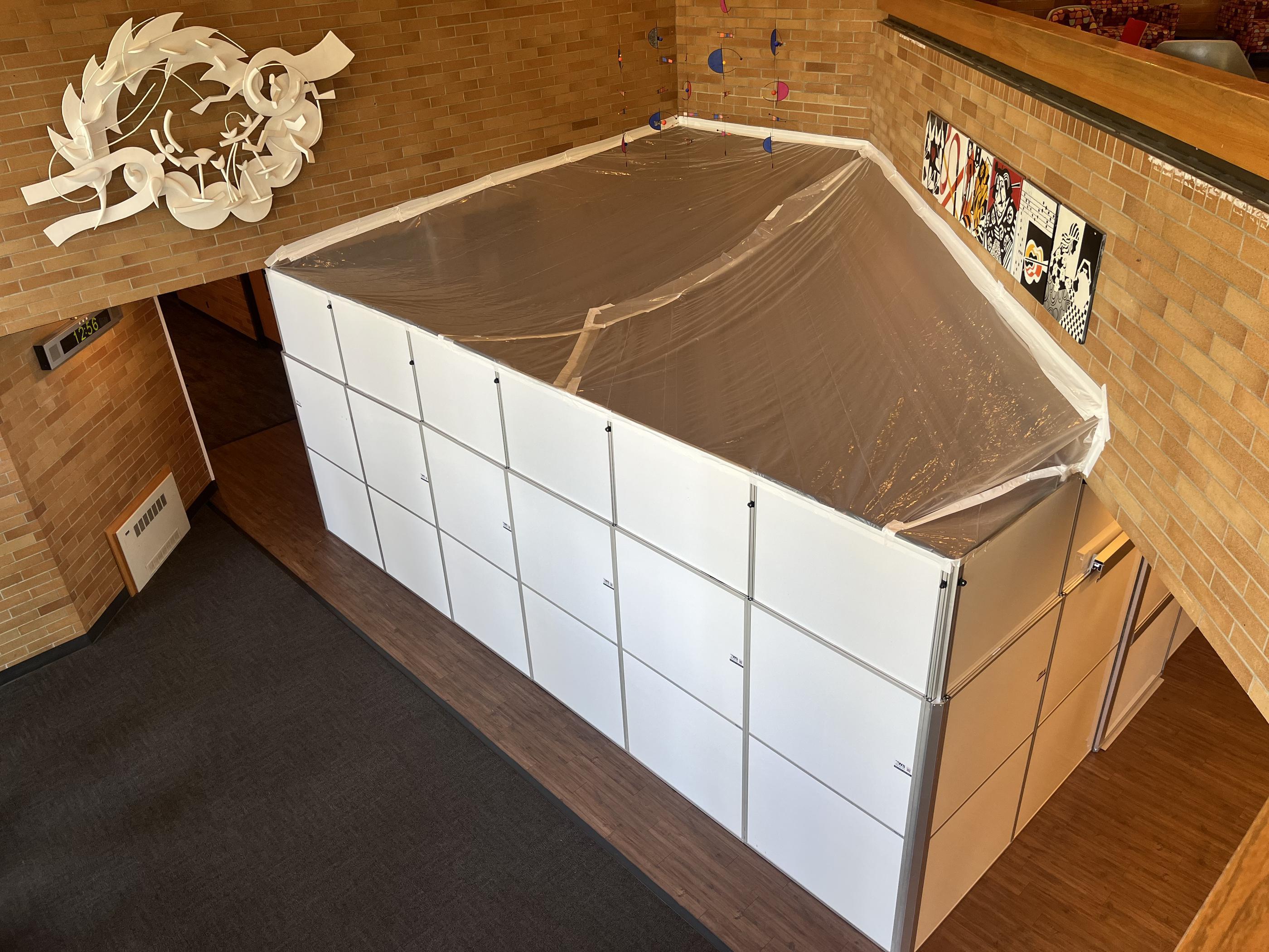 Overhead view of an enclosed renovation area with modular walls and sealed plastic covering inside Boswell Hall.
