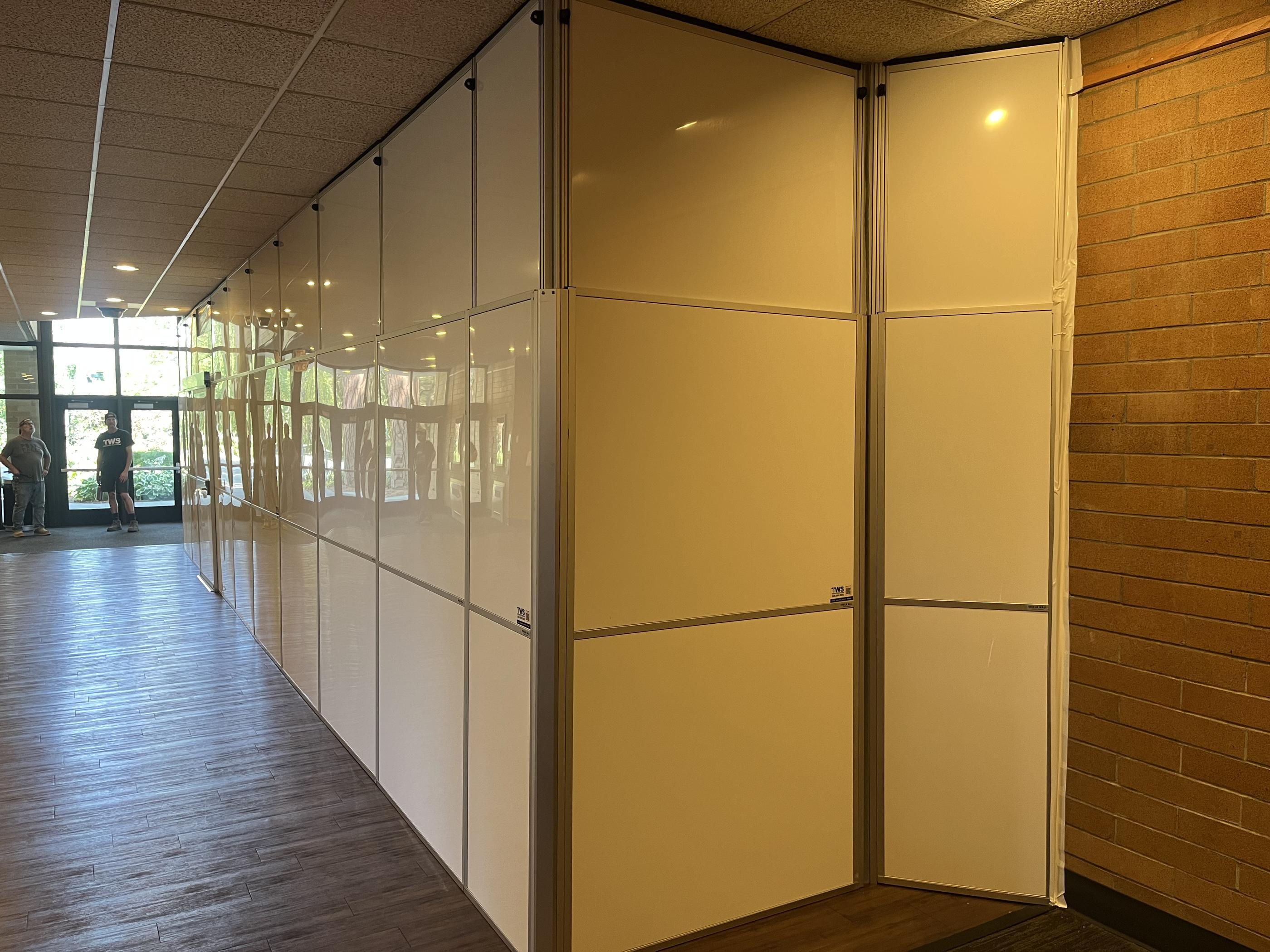 Modular temporary wall creating a clean separation through the occupied lobby at Boswell Hall.