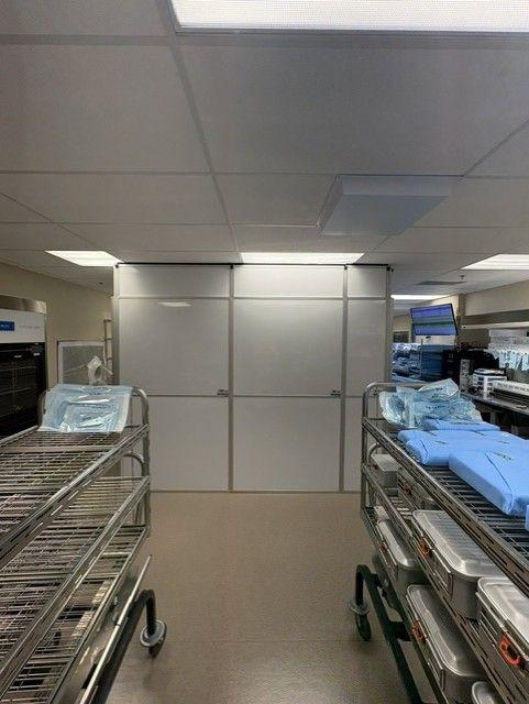 Temporary Wall Systems modular hard wall containment enclosure installed inside occupied healthcare sterile processing lab for construction containment and infection prevention