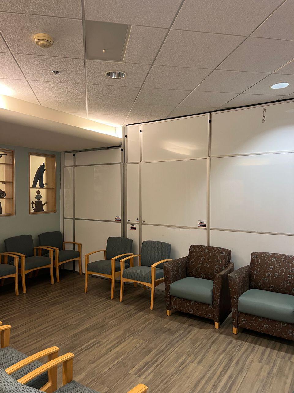 Temporary Wall Systems modular hard wall containment installed inside occupied cardiology infusion lobby waiting area during healthcare renovation