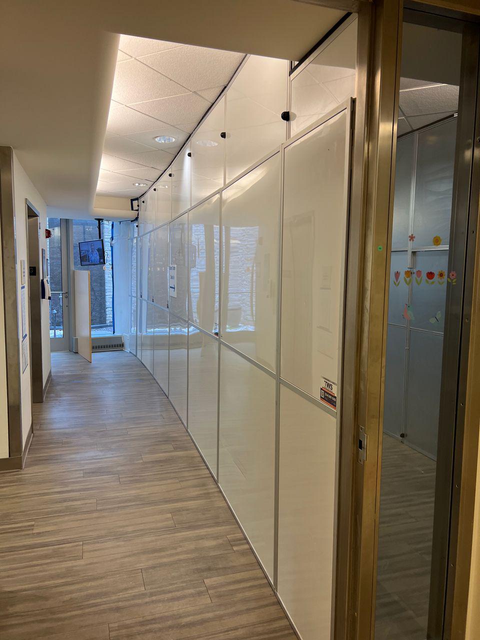 Healthcare construction containment corridor with modular temporary walls separating renovation work from active patient care areas at Missouri Baptist Medical Center
