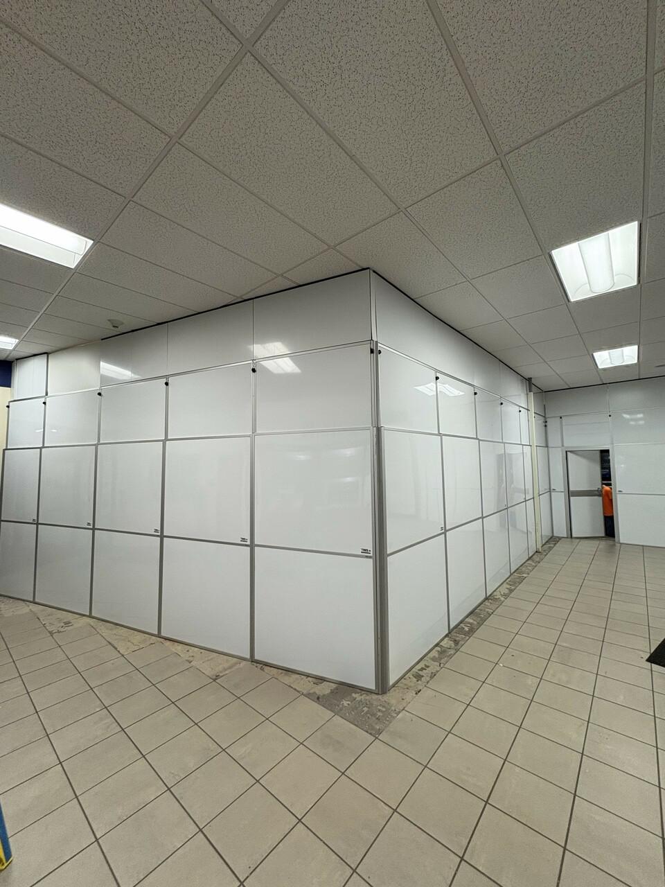 Modular hard wall containment system installed by Temporary Wall Systems to separate active construction areas inside occupied commercial banking facility in Anchorage Alaska