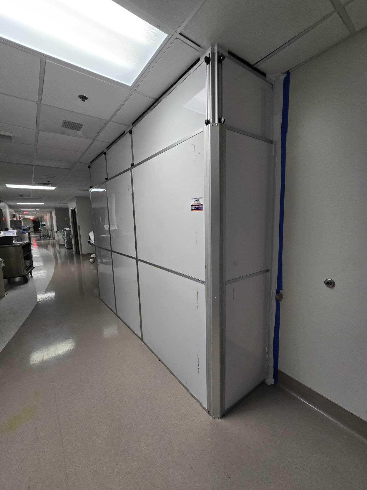 Healthcare containment wall with sealed edges installed to separate renovation work from occupied hospital space.