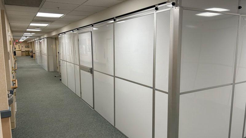 white temporary wall in long hallway