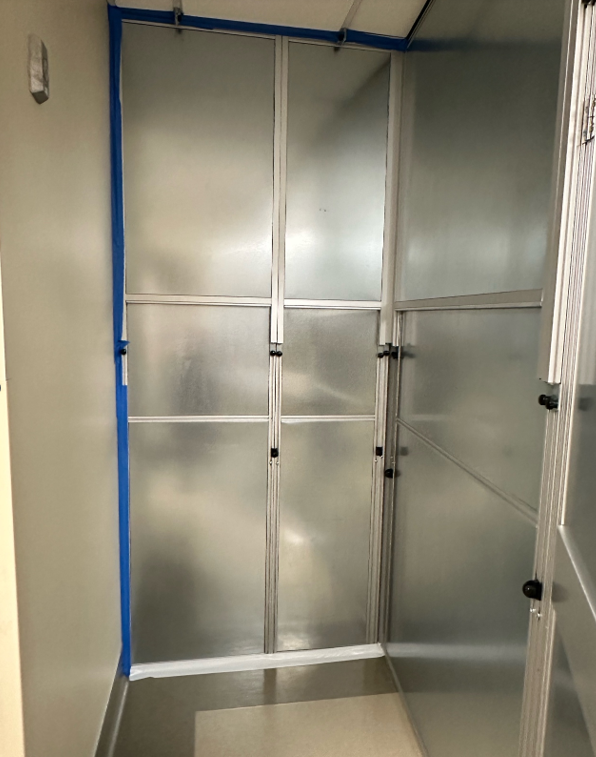 Modular hard wall containment corridor installed by Temporary Wall Systems to separate hospital renovation work from occupied healthcare spaces and maintain safe traffic flow.