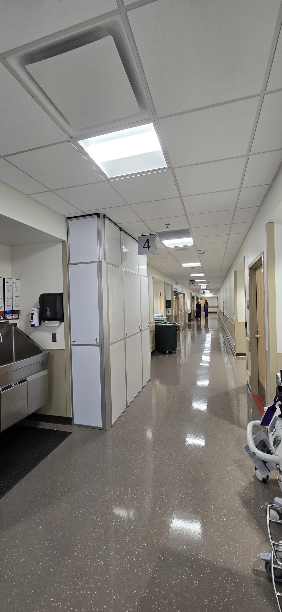 Temporary containment wall inside occupied UTSW Dallas facility with clean, professional healthcare installation