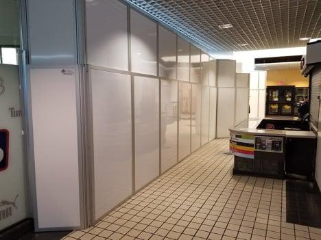 Temporary Wall Systems modular walls blocking off an area in a dimly lit office.