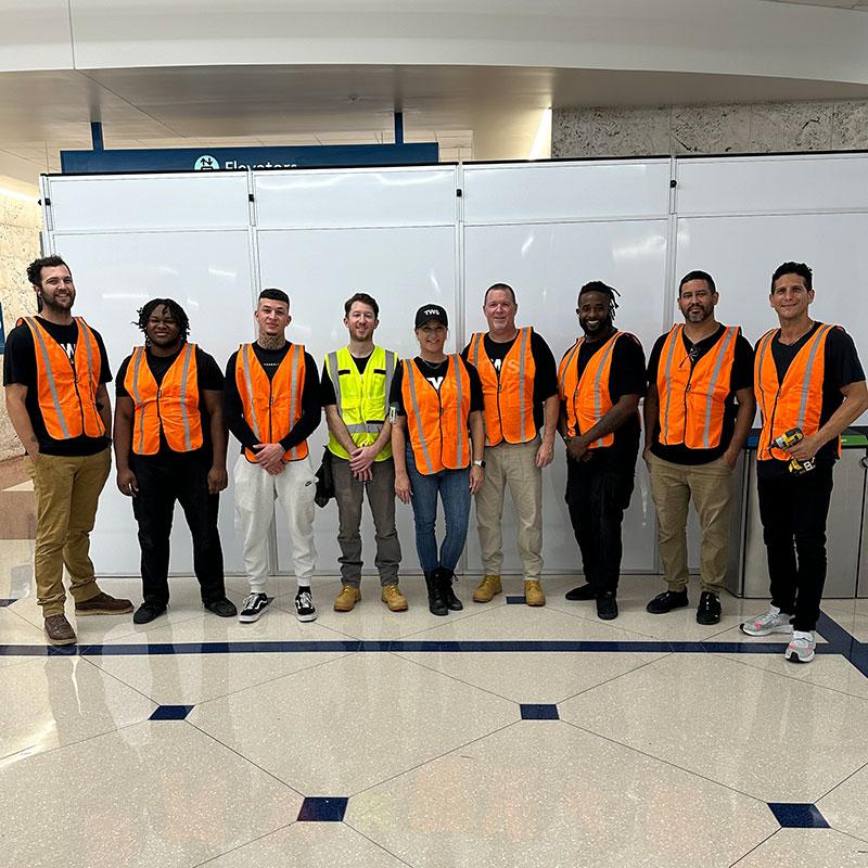 team photo in front of white temporary wall
