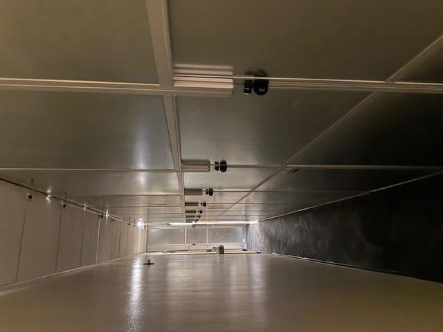 Temporary construction walls installed on both sides of a hallway renovation project in a government building