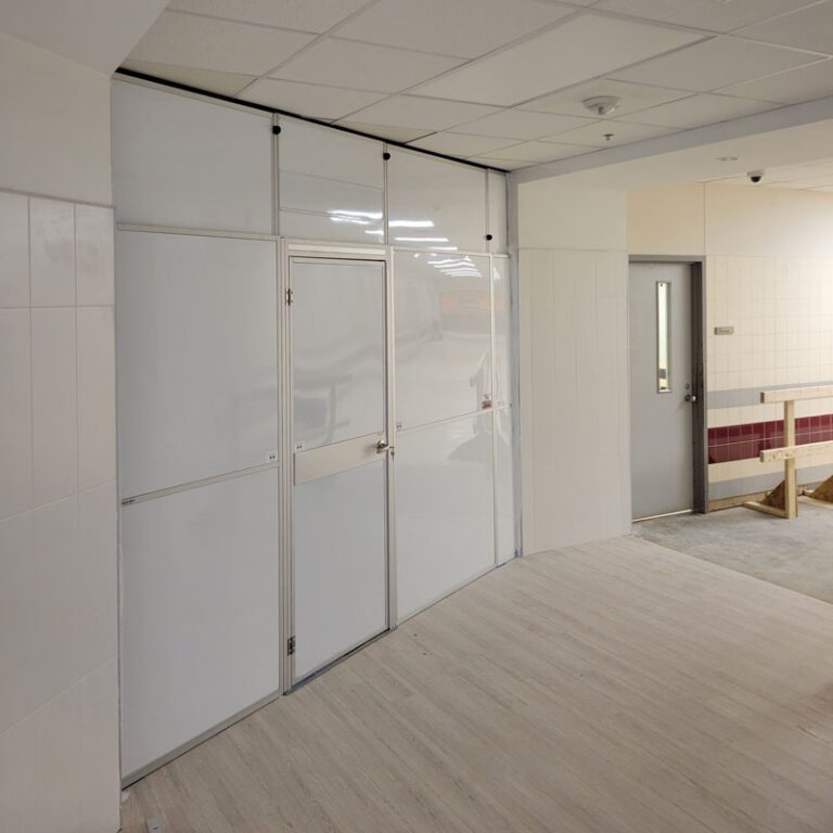 A relaxing all-white bathroom with marbled floor tiles, a double sink vanity with marbled counters, and a spacious built-in linen cabinet