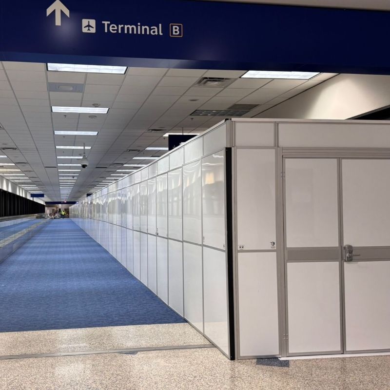 temporary walls in an airport with a blue carpet