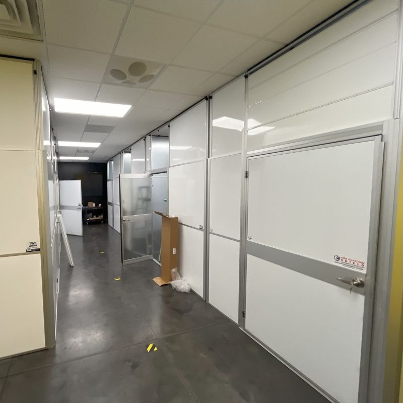 temporary walls set up in a hallway with a black floor