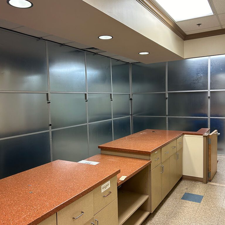 Contemporary black and white bathroom double sink vanity with white shaker lower cabinets and a black stone countertop