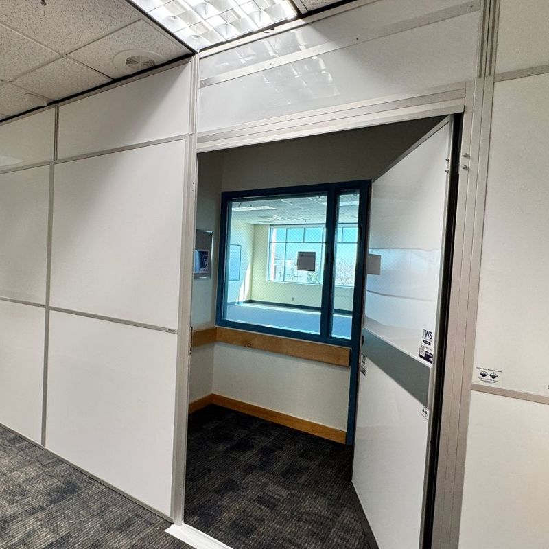 temporary wall with a door on a dark color carpet