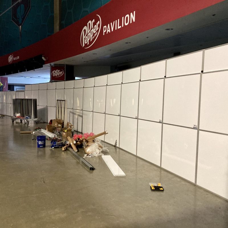 temporary walls in the spectrum center with a red dr. pepper banner above the walls