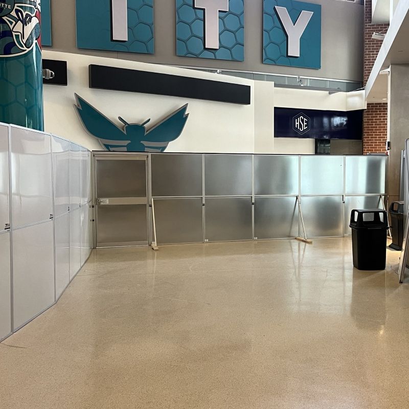 temporary wall systems in the spectrum center in front of a charlotte hornets sign