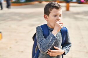 coughing child dust in classroom